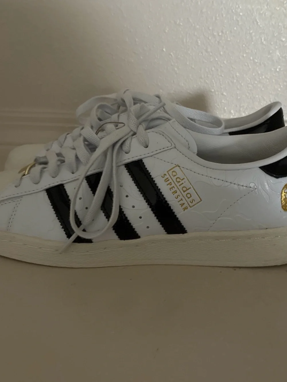 Bape White Sneakers with Black Stripes and Gold Tongue Accents